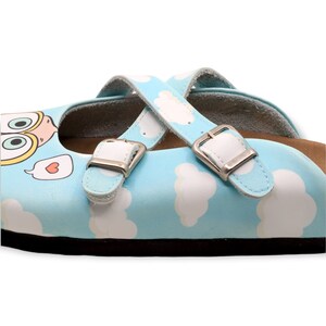 May include: Light blue leather children's shoes with white cloud print and two adjustable straps with silver buckles.