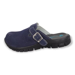 May include: A navy blue suede clog with a buckle strap and a black rubber sole. The clog has a perforated design and a cushioned footbed.