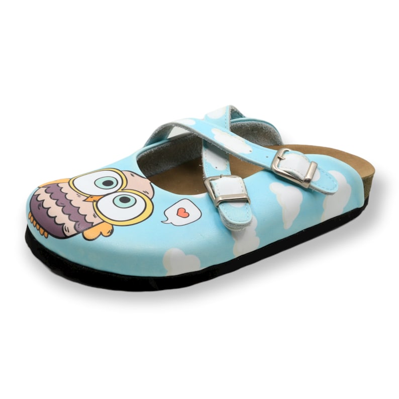 May include: Light blue children's slip-on shoe with a cartoon owl design and two adjustable straps with white buckles. The shoe has a white cloud pattern and a black sole.
