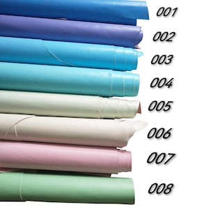 May include: Eight rolls of leather in different colors, including light blue, blue, turquoise, green, pink, white, cream, and lavender. The rolls are numbered 001 through 008.