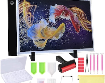 May include: Diamond painting kit with a light pad, tools, and a tray of diamonds. The light pad has a power button and clips to hold the canvas in place. The tools include a roller, tweezers, a diamond pick-up tool, and a tray for sorting diamonds. The canvas features a colorful image of two betta fish.