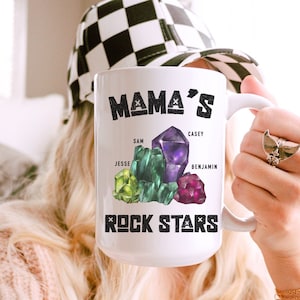 May include: White ceramic mug with the text "Mama's Rock Stars" and four colorful gemstones labeled with the names Sam, Casey, Jesse, and Benjamin.