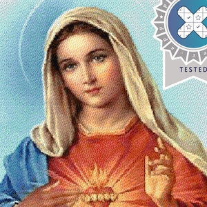 May include: A cross-stitch pattern featuring the Virgin Mary wearing a red tunic and blue mantle with a head covering. A glowing heart is centered on the chest. A circular blue badge in the top right corner contains the text Pattern Keeper Tested.