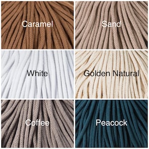 May include: Close-up of six spools of cotton cord in different colors: caramel, sand, white, golden natural, coffee, and peacock.