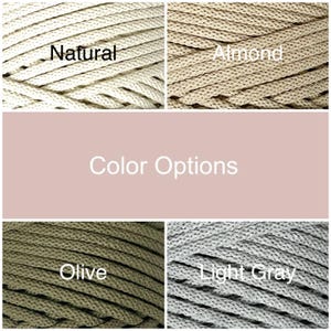 May include: Close-up of four different colored ropes: Natural, Almond, Olive, and Light Gray. The text "Color Options" is displayed in a pink rectangle. The ropes are tightly woven and appear to be made of a durable material.