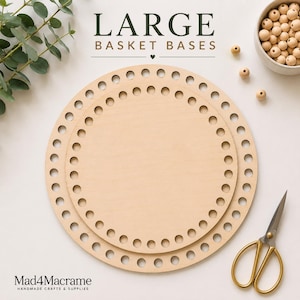 May include: Two circular light-colored wooden basket bases with evenly spaced holes along the perimeter for weaving. The text LARGE BASKET BASES is centered above the wooden discs, with a small bowl of wooden beads and gold scissors nearby.