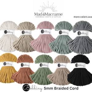 May include: Assortment of 10 spools of 5mm braided cord in various colors, including white, beige, pink, green, gray, yellow, orange, sage, tan, and black. The cord is labeled "Bobbiny 5mm Braided Cord".
