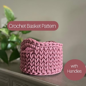 May include: A pink crocheted basket with handles. The basket is made with a textured stitch pattern. Crochet Basket Pattern with Handles.