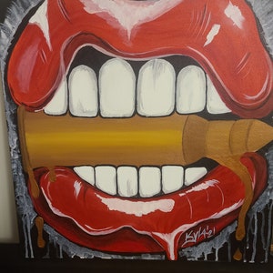 May include: A painting of a large, red, open mouth with white teeth biting down on a gold bullet. The mouth is dripping with red and gold paint.