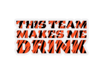 May include: A sticker with an orange and black tiger stripe pattern that says "This team makes me drink".