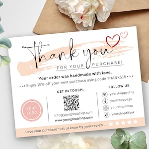 May include: Thank you card with a pink and white background. The card has a handwritten thank you message, a heart graphic, and a QR code. The card also includes social media handles and a discount code.