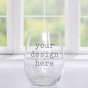 May include: Clear glass stemless wine glass with the text "your design here" printed on the side.