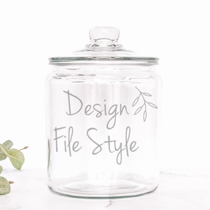 May include: A clear glass jar with a lid, featuring the text "Design File Style" and a small twig design.