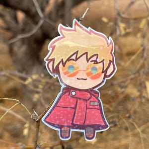 May include: A cartoon sticker of a person with blond hair wearing red clothing and sunglasses. The sticker has a sparkly, iridescent finish.