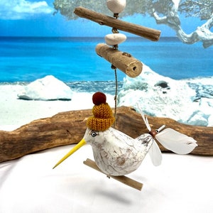 Seagull, with cap, wind chime with moving feathers as tail, fluttering gull, sandpiper, seagulls on a rope with driftwood, propeller, seagull,