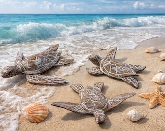 May include: Four wooden turtle sculptures with detailed shell patterns are arranged on a sandy beach with seashells and a starfish. The ocean waves gently lap the shore in the background, under a blue sky.