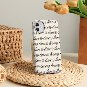 May include: A set of three ceramic mugs with a speckled, matte finish. The mugs are in shades of cream, light gray, and dark gray. Each mug has a simple, minimalist design and a rounded handle.
