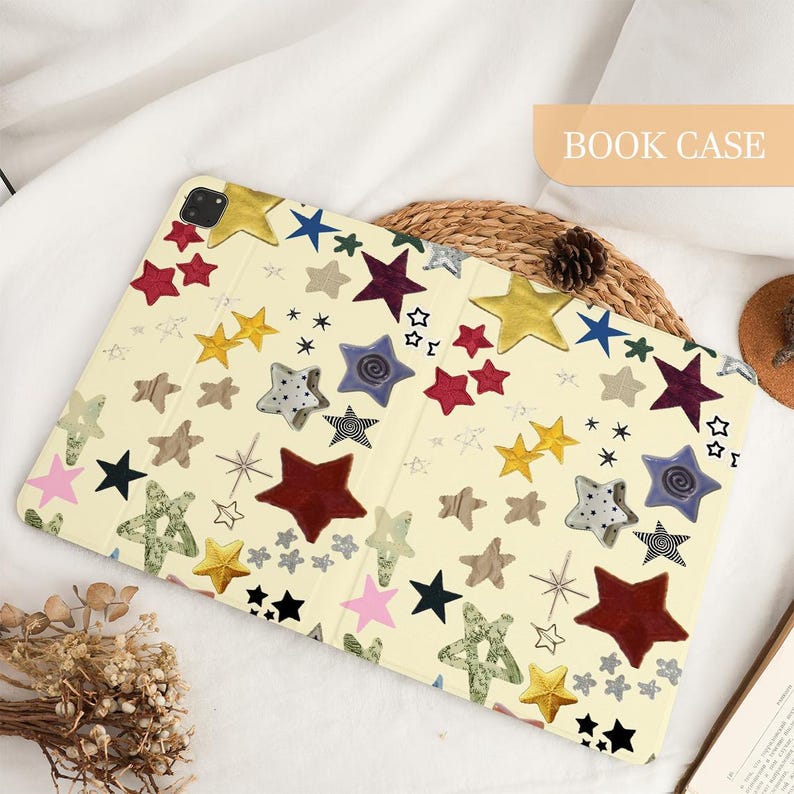 May include: A cream-colored book case with a colorful star pattern. The stars are in various colors, including red, yellow, blue, and green. The text "BOOK CASE" is in a rectangular box in the upper right corner.