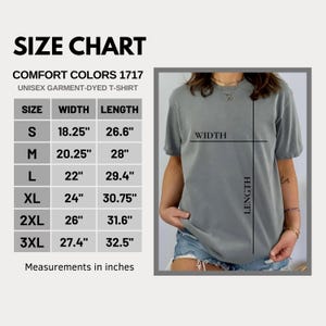 May include: A size chart for a Comfort Colors 1717 unisex garment-dyed t-shirt. The chart lists sizes S through 3XL with corresponding width and length measurements in inches. A grey t-shirt is shown with lines indicating width and length.