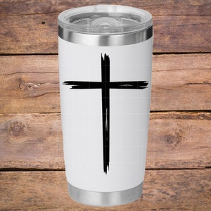 May include: White stainless steel tumbler with a black brushstroke cross design.