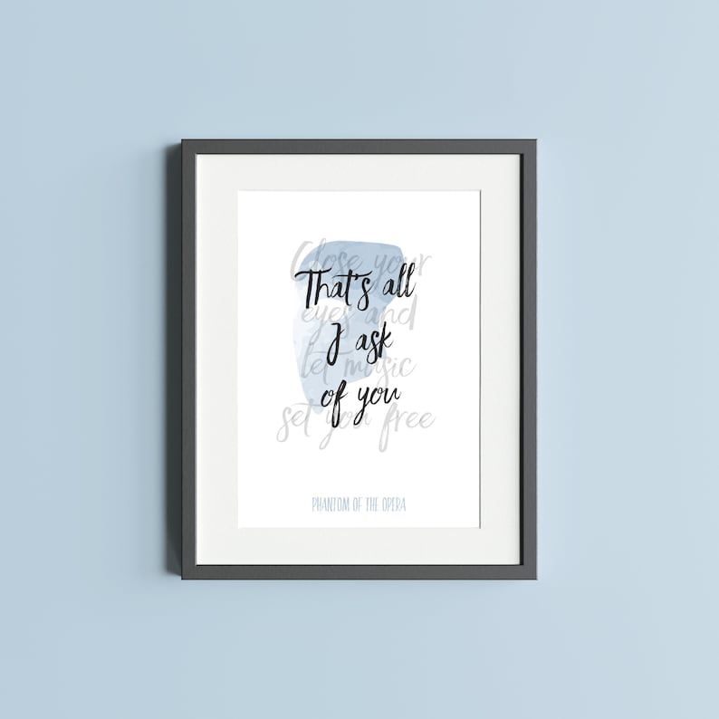 May include: A framed print with a blue watercolor background and the text "Close your eyes and let music set you free. That's all I ask of you."  The text is in black and the words "Phantom of the Opera" are printed below the text.