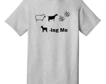 May include: A gray t-shirt with a black sheep, goat, and bee design. The text " -ing Me" is printed below the design.