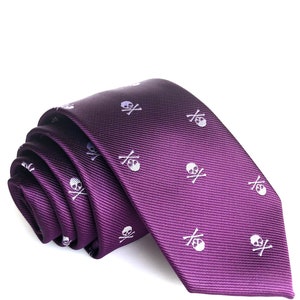 May include: A purple silk tie with a white skull and crossbones pattern.