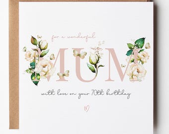 May include: A square greeting card with a brown envelope featuring the text "for a wonderful MUM" and "with love on your 70th birthday" in a script font. The word MUM is decorated with watercolor illustrations of white roses and green leaves.