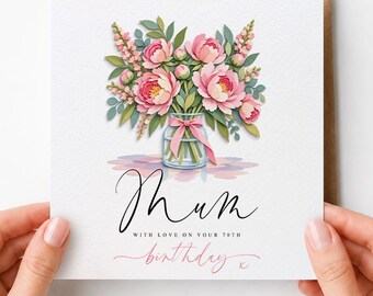 May include: A square greeting card featuring a watercolor illustration of a bouquet of pink peonies and green leaves in a glass jar with a pink ribbon. The text reads Mum, with love on your 70th birthday, in black and pink script lettering.
