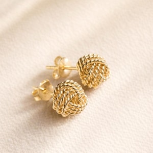 May include: A set of three ceramic mugs with a speckled, matte finish. The mugs are in shades of cream, light gray, and dark gray. Each mug has a simple, minimalist design, perfect for coffee or tea.