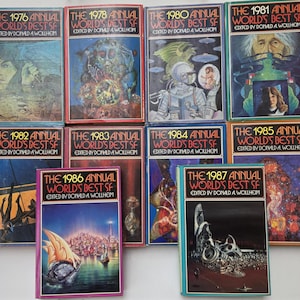 May include: A collection of vintage science fiction books, each with unique cover art. Titles include "The 1976 Annual World's Best SF" to "The 1987 Annual World's Best SF", edited by Donald A. Wollheim. The covers feature illustrations of space themes.