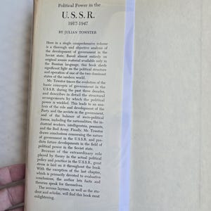 May include: A vintage book titled "Political Power in the U.S.S.R. 1917-1947" by Julian Towster. The cover is off-white with black text. The book is open, revealing the title and description of the book's contents.