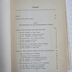 May include: Open book displaying a table of contents. The text includes "Preface", "Introduction by Quincy Wright", and "The Principles of the Constitutional Order". The page numbers are visible. The book is open on a light-colored surface.