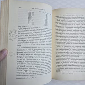 May include: Open book with text and a handwritten note. The page displays a list of dates and figures under the heading "The Party Structure (I)". The text discusses the Komsomol's role in Soviet society and its activities.