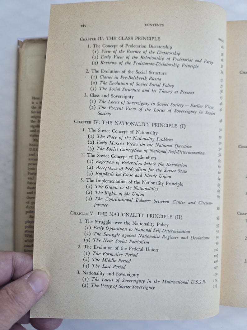 May include: Open book page with a table of contents. The text includes chapter titles such as "The Class Principle" and "The Nationality Principle." The page is yellowed with age.