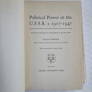 May include: Open book with the title "Political Power in the U.S.S.R. 1917-1947". The cover features text including the author's name, Julian Towster, and the publisher, Oxford University Press. The book's theme is the theory and structure of government in the Soviet State.