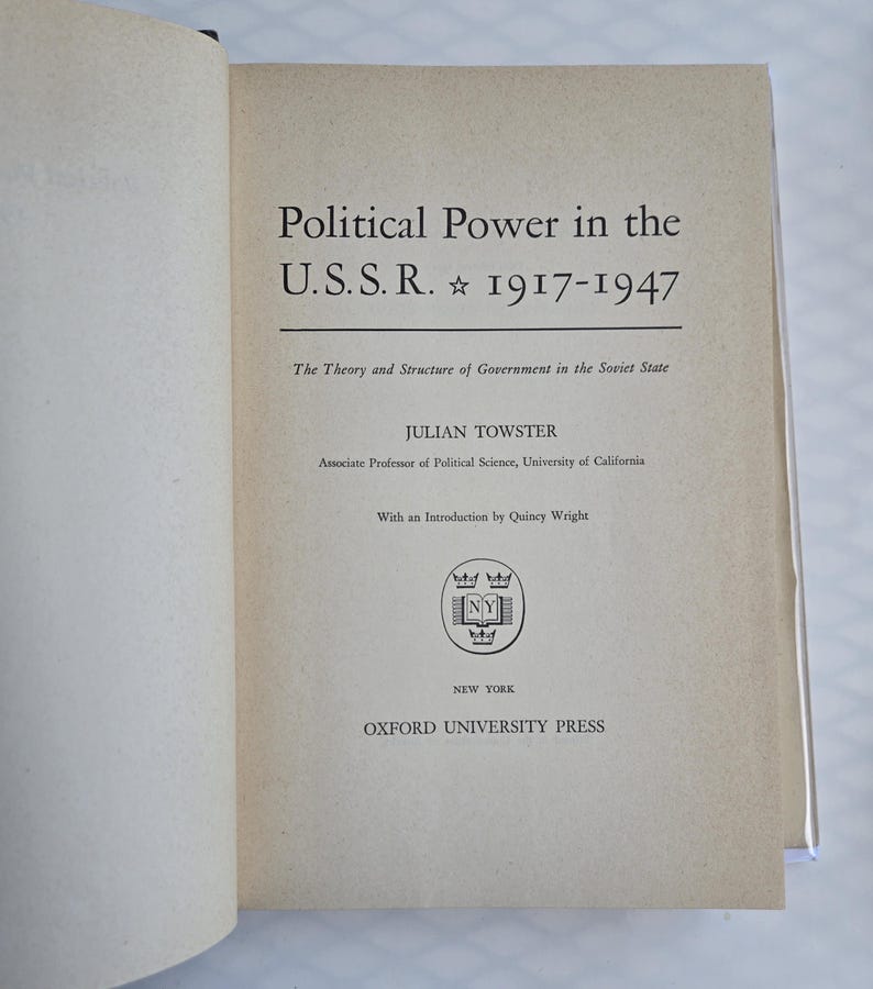 May include: Open book with the title "Political Power in the U.S.S.R. 1917-1947". The cover features text including the author's name, Julian Towster, and the publisher, Oxford University Press. The book's theme is the theory and structure of government in the Soviet State.