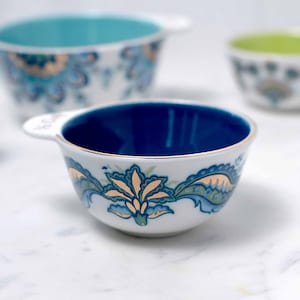 Each of Mary DiSomma's beautiful nested ceramic measuring cups has its own unique floral pattern design and different colored interiors.