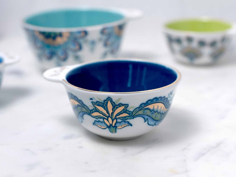 Each of Mary DiSomma's beautiful nested ceramic measuring cups has its own unique floral pattern design and different colored interiors.