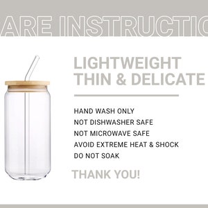 May include: A clear glass can with a wooden lid and a glass straw. The can has the text "CARE INSTRUCTION", "LIGHTWEIGHT", "THIN & DELICATE", "HAND WASH ONLY", "NOT DISHWASHER SAFE", "NOT MICROWAVE SAFE", "AVOID EXTREME HEAT & SHOCK", "DO NOT SOAK", and "THANK YOU!" printed on it.