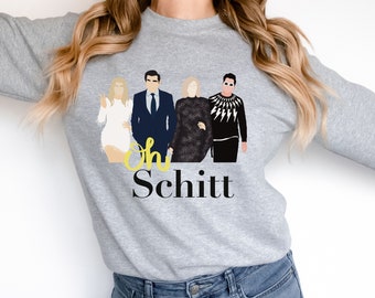 Könnte beinhalten: Ein grauer Pullover mit einem grafischen Druck von vier Personen, die zusammen stehen. Der Text "Oh Schitt" ist unter den Personen gedruckt.