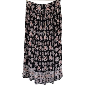 May include: A black maxi skirt with a pink and white floral print. The skirt has a drawstring waist and a tiered design.