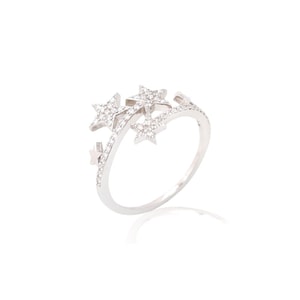 May include: A silver ring with a design of three stars set with clear cubic zirconia stones.