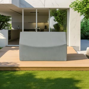 May include: A rectangular, light gray protective cover designed for outdoor furniture. The cover features a textured, woven fabric surface and is shaped to fit over a bench or similar seating piece, providing full coverage with clean, straight edges.
