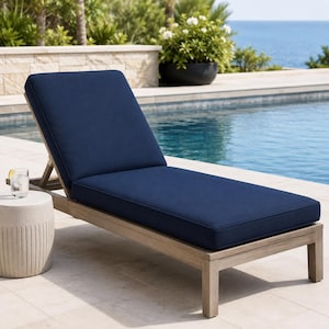 May include: A wooden chaise lounge chair featuring a thick, solid navy blue cushion. The frame is constructed from light brown wood with a natural finish. The backrest is adjustable, and the seat is long, providing a flat surface for reclining.