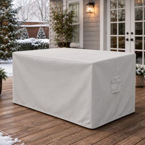May include: A rectangular, light gray outdoor furniture cover made of a smooth, solid-colored fabric. The cover features a structured, boxy shape with reinforced seams and a small, rectangular handle or pocket detail on the side panel.