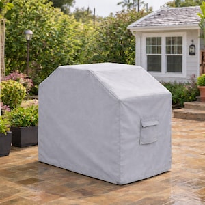 May include: A light gray, rectangular protective cover designed for an outdoor grill. The cover features a smooth, durable fabric construction with reinforced seams and a small, square-shaped storage pocket located on the side panel.
