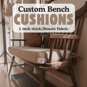 May include: Custom bench cushions made with boucle fabric. The cushions are 3 inches thick and are shown on a wooden bench with a woven basket.