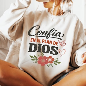May include: A white ceramic mug with a black handle and the text "But First, Coffee" in a bold, black font. The mug is set against a blurred background, suggesting a cozy setting.