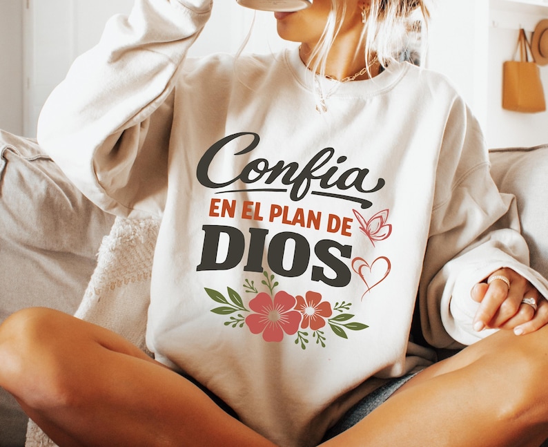 May include: A white ceramic mug with a black handle and the text "But First, Coffee" in a bold, black font. The mug is set against a blurred background, suggesting a cozy setting.